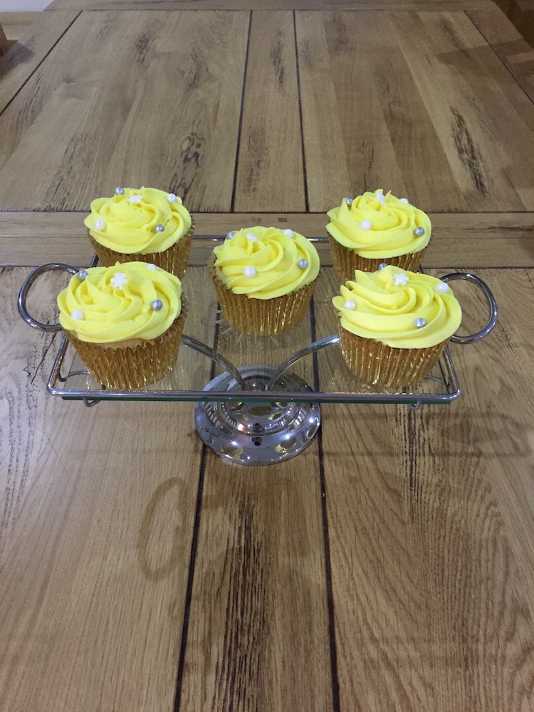 Gluten Free Cupcakes with yellow icing on a cake stand